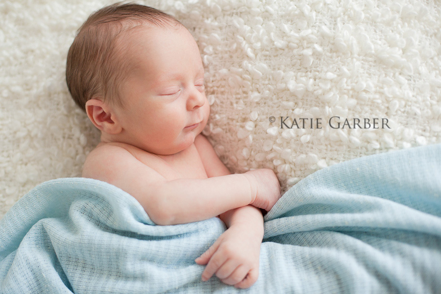 newborn boy with blanket