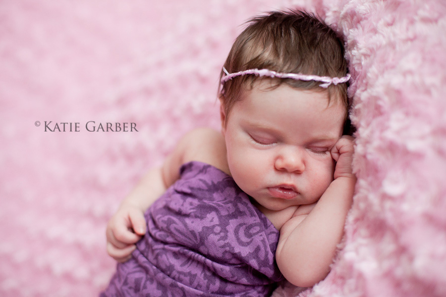 newborn swaddled with headband