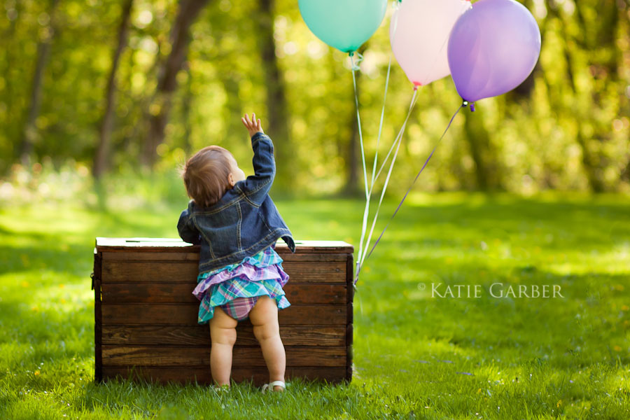 baby girl looking at balloons