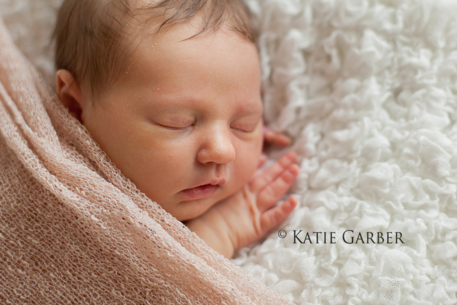 baby girl cuddled in blanket