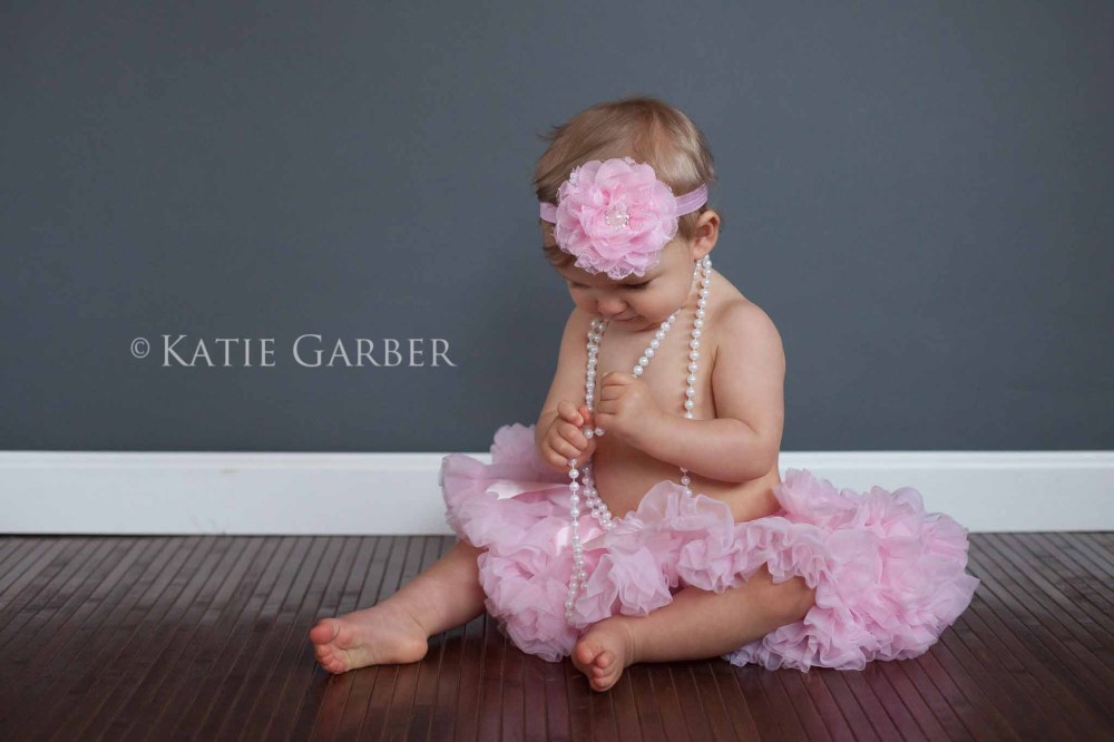 baby playing with pearls