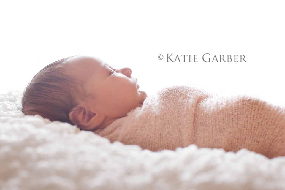 swaddled newborn backlighting