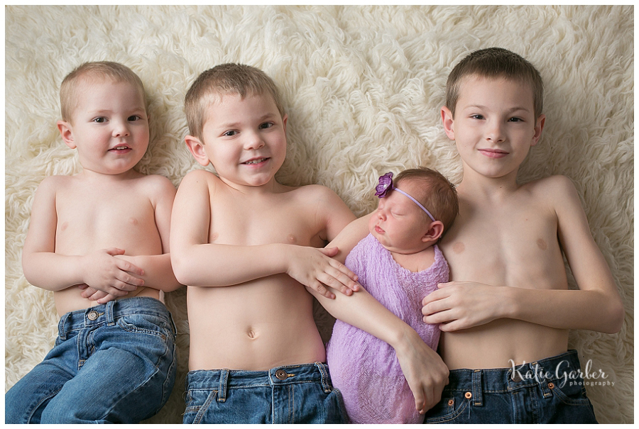 baby girl with three siblings on flokati