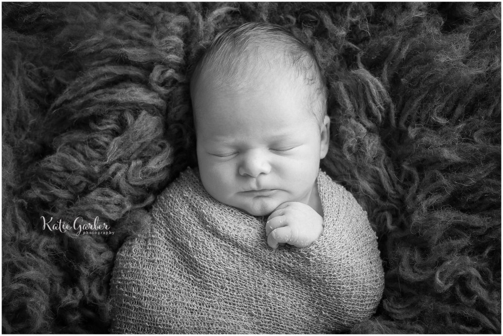 black and white newborn baby on flokati