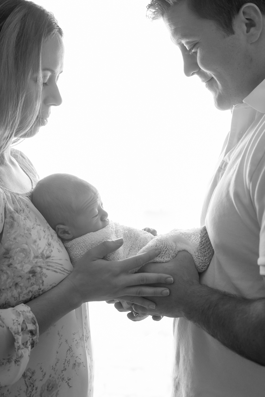 newborn family of three backlit