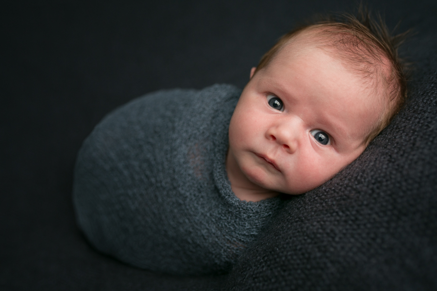 newborn swaddled wide awake